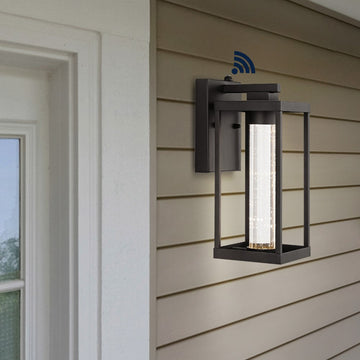 Juno 4.75" Industrial Vintage Iron/Glass Seeded Glass with Dusk-to-Dawn Sensor Integrated LED Outdoor Sconce - JONATHAN Y